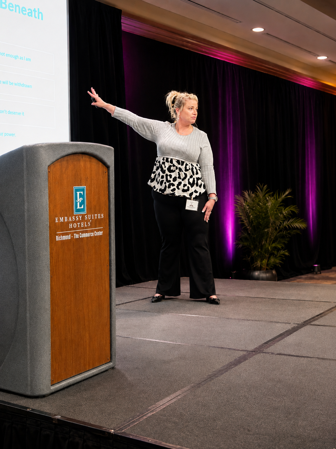Lindsey Eye speaking on stage at a leadership summit keynote